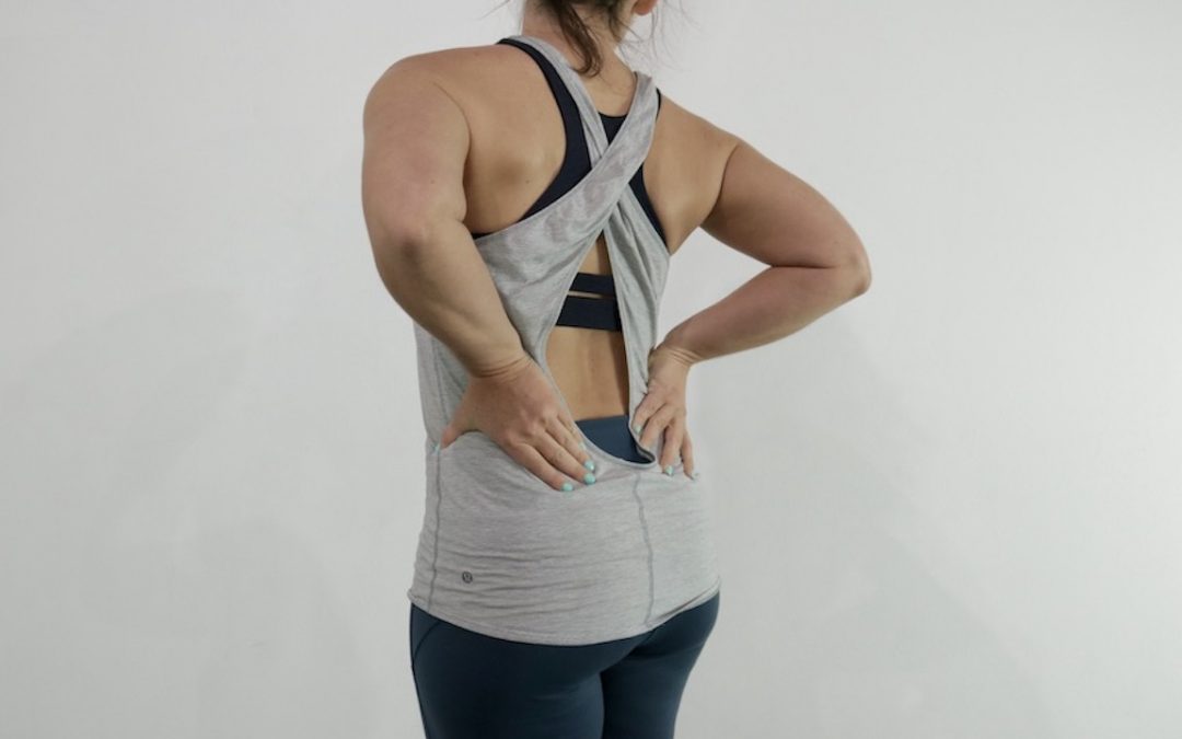 woman holding pressure in lower back